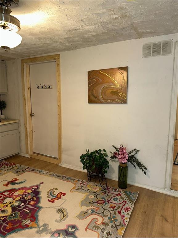 300 W Sea Ave, Independence, MO 64050 - interior space featuring visible vents and light wood finished floors