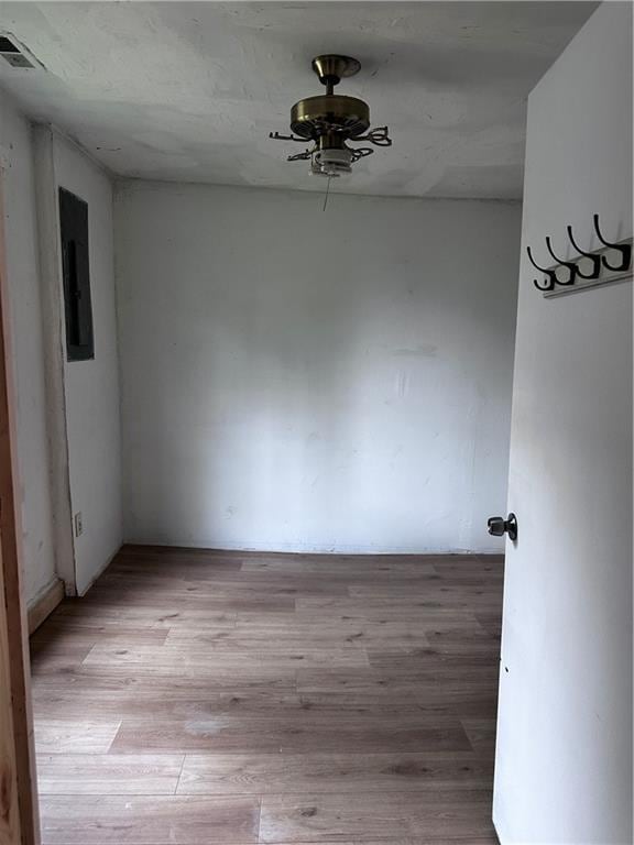 300 W Sea Ave, Independence, MO 64050 - spare room with light wood finished floors, visible vents, a ceiling fan, and electric panel