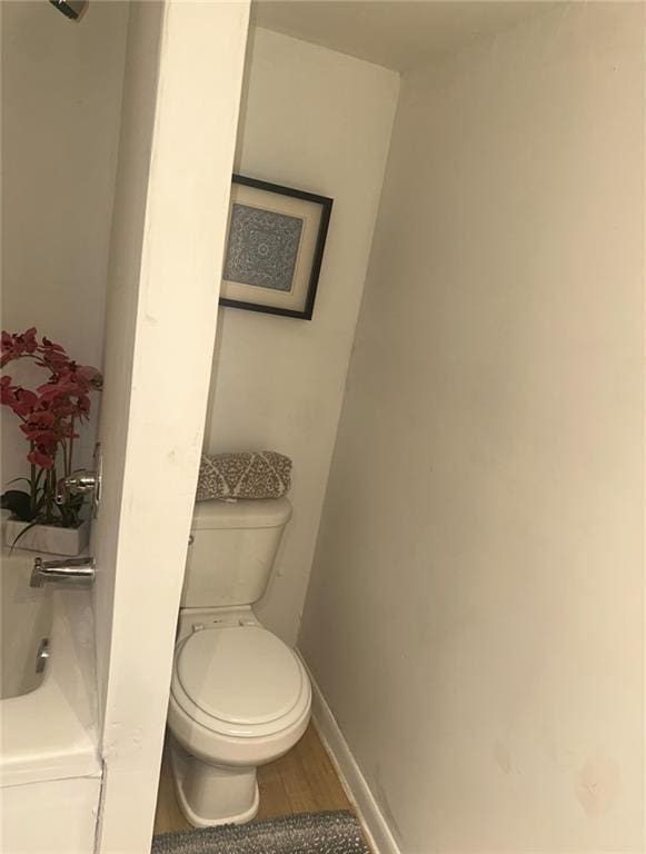 300 W Sea Ave, Independence, MO 64050 - bathroom featuring wood finished floors, toilet, and baseboards