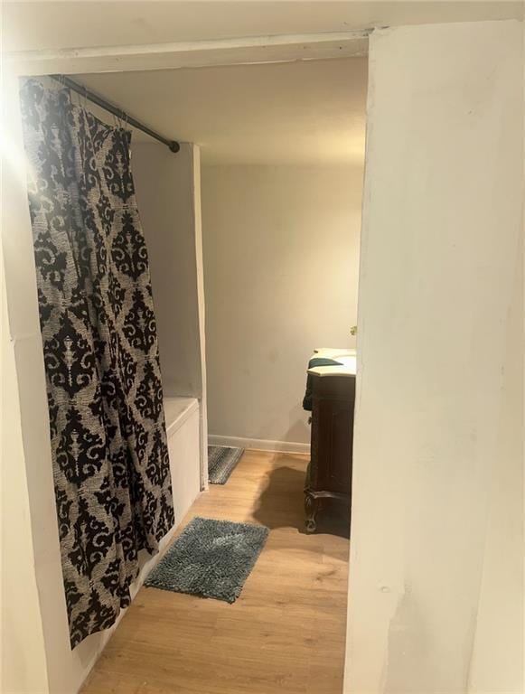 300 W Sea Ave, Independence, MO 64050 - bathroom with baseboards, curtained shower, wood finished floors, and vanity