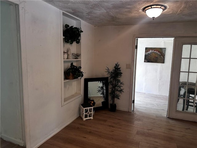 300 W Sea Ave, Independence, MO 64050 - hall with wood finished floors, a textured ceiling, and baseboards