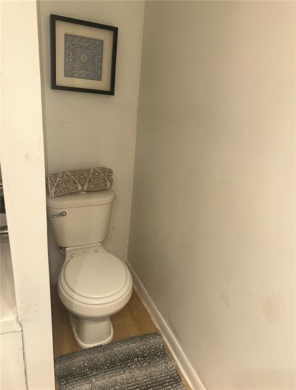 300 W Sea Ave, Independence, MO 64050 - bathroom with baseboards, wood finished floors, and toilet