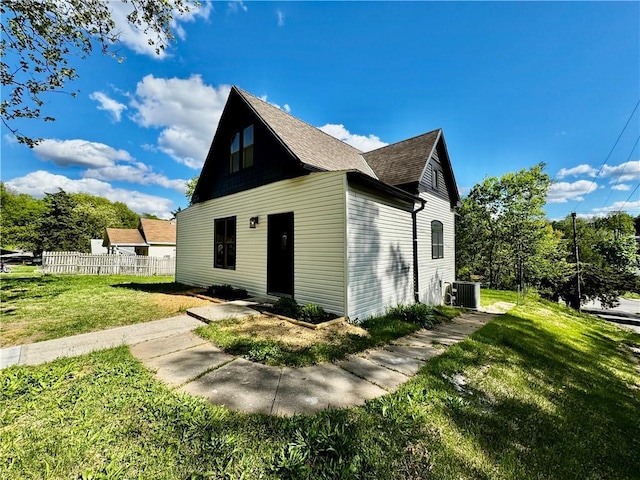 1502 6th Ave, Saint Joseph, MO 64505 - bungalow with a shingled roof, a front lawn, fence, and cooling unit