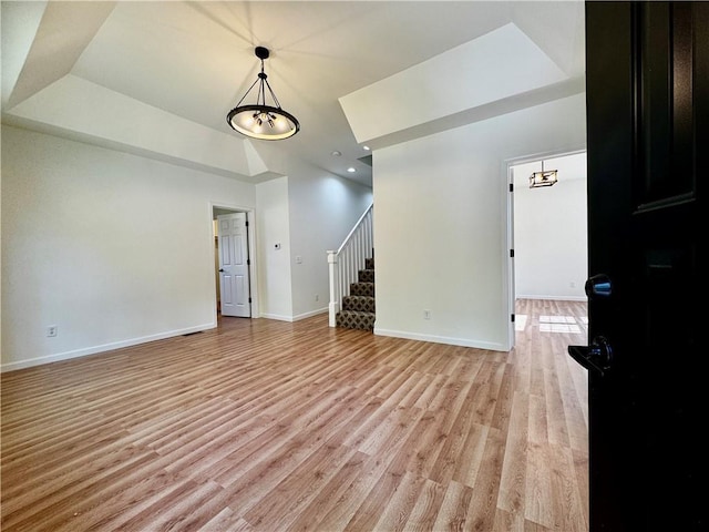 1502 6th Ave, Saint Joseph, MO 64505 - unfurnished living room with baseboards, recessed lighting, stairs, and light wood finished floors