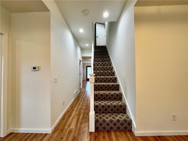 1502 6th Ave, Saint Joseph, MO 64505 - staircase with recessed lighting, baseboards, wood finished floors, and visible vents