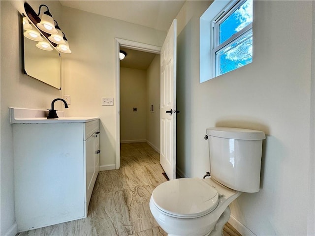 1502 6th Ave, Saint Joseph, MO 64505 - half bathroom featuring baseboards, marble finish floor, toilet, and vanity