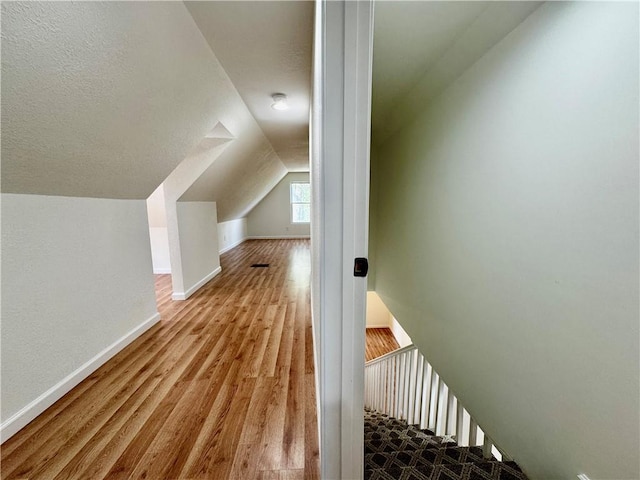 1502 6th Ave, Saint Joseph, MO 64505 - additional living space featuring baseboards, wood finished floors, and vaulted ceiling