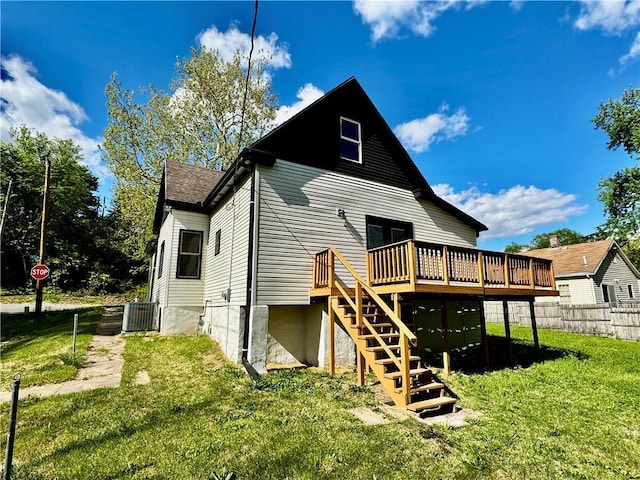1502 6th Ave, Saint Joseph, MO 64505 - rear view of house with fence, central AC, a wooden deck, stairway, and a lawn