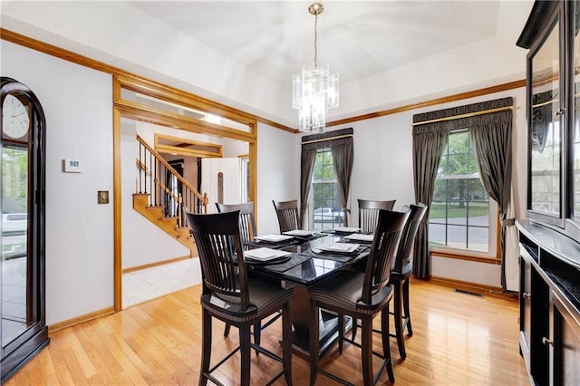 dining space with visible vents, stairs, baseboards, light wood-style flooring, and a notable chandelier