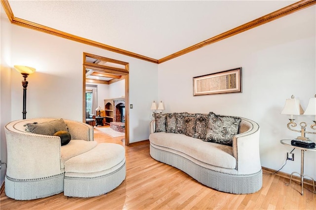 living area with crown molding, baseboards, and wood finished floors
