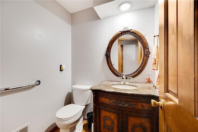 half bathroom with toilet and vanity