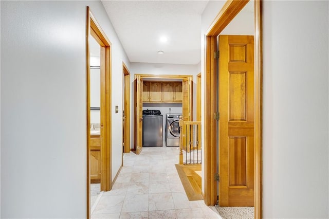 corridor featuring separate washer and dryer and an upstairs landing