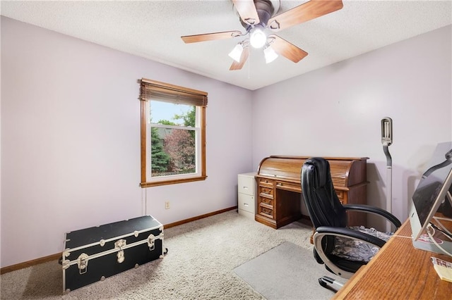 carpeted home office featuring baseboards, a ceiling fan, and a textured ceiling