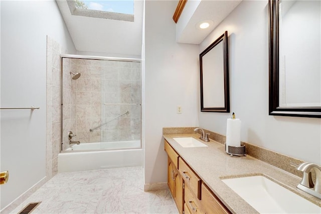 full bath featuring a sink, combined bath / shower with glass door, double vanity, and visible vents