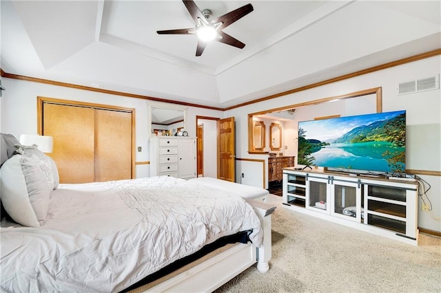 carpeted bedroom featuring crown molding, a raised ceiling, a ceiling fan, and visible vents