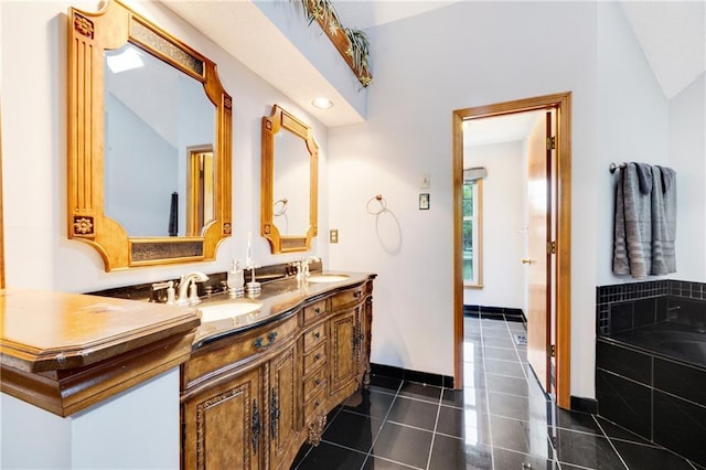 full bathroom with double vanity, tiled bath, a sink, and tile patterned flooring