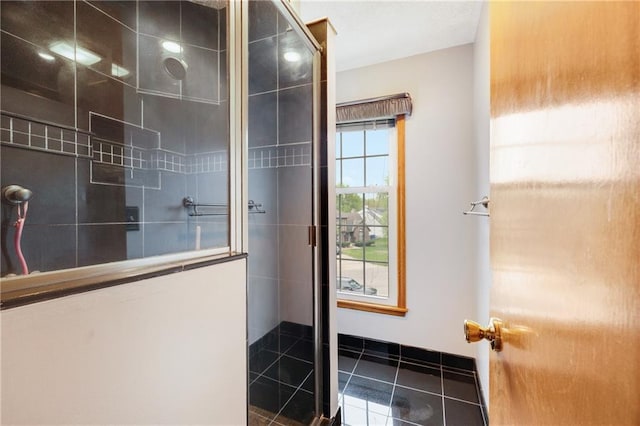 bathroom featuring tile patterned floors and a tile shower