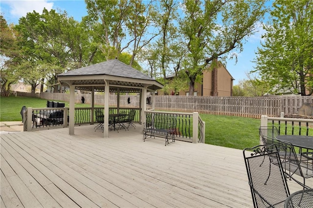 wooden terrace with a gazebo, a lawn, and outdoor dining space