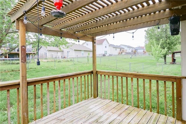 deck with a residential view, a pergola, a yard, and a fenced backyard