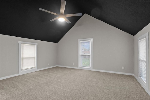 additional living space with plenty of natural light, ceiling fan, lofted ceiling, and light carpet