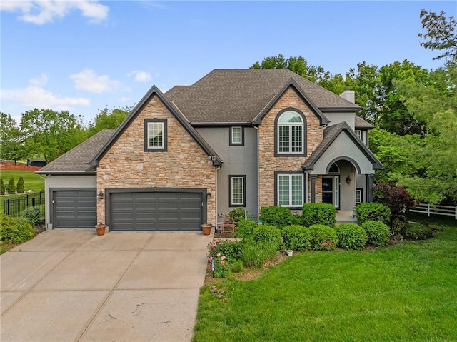 6715 NW 102nd Ter, Kansas City, MO 64154 - view of front of property with driveway, stone siding, stucco siding, and roof with shingles