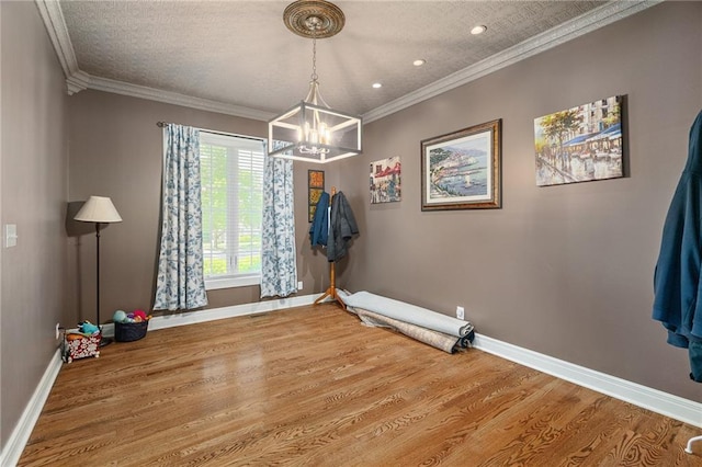6715 NW 102nd Ter, Kansas City, MO 64154 - unfurnished dining area with a chandelier, baseboards, wood finished floors, recessed lighting, and crown molding