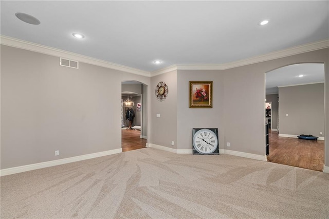 6715 NW 102nd Ter, Kansas City, MO 64154 - empty room with arched walkways, carpet floors, ornamental molding, baseboards, and recessed lighting