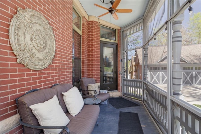 sunroom / solarium featuring ceiling fan and a wealth of natural light