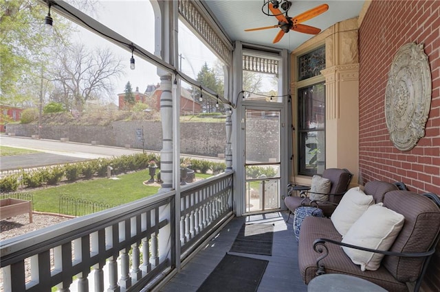 sunroom featuring ceiling fan and a wealth of natural light