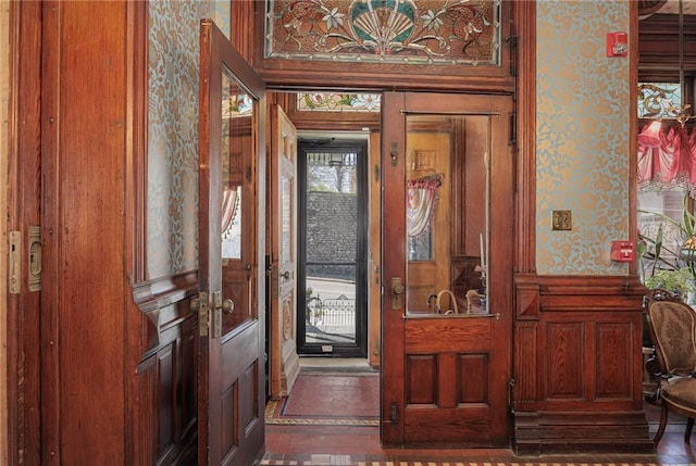 foyer entrance with wallpapered walls