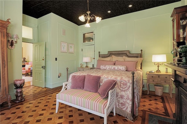 bedroom featuring recessed lighting and a notable chandelier