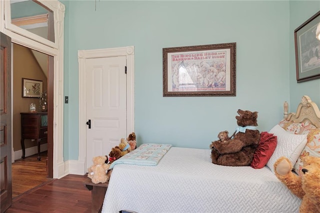 bedroom featuring baseboards and wood finished floors