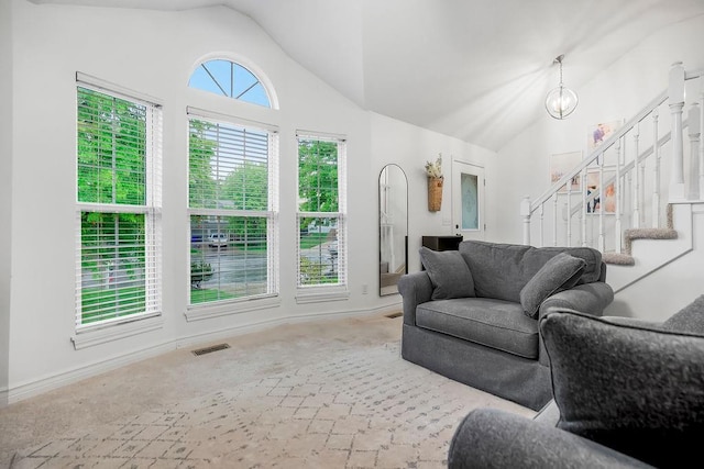 17525 W 111th Ct, Olathe, KS 66061 - living area featuring vaulted ceiling, carpet floors, stairs, a chandelier, and baseboards