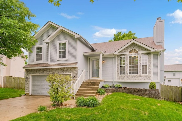 17525 W 111th Ct, Olathe, KS 66061 - split level home with stone siding, a garage, driveway, and a chimney
