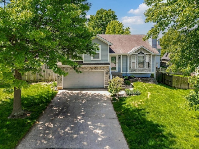 17525 W 111th Ct, Olathe, KS 66061 - split level home with an attached garage and concrete driveway