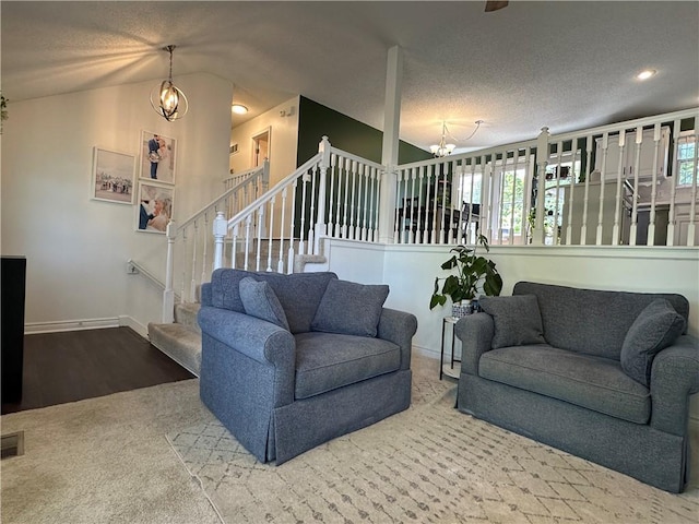 17525 W 111th Ct, Olathe, KS 66061 - living room featuring a chandelier, stairway, wood finished floors, vaulted ceiling, and baseboards