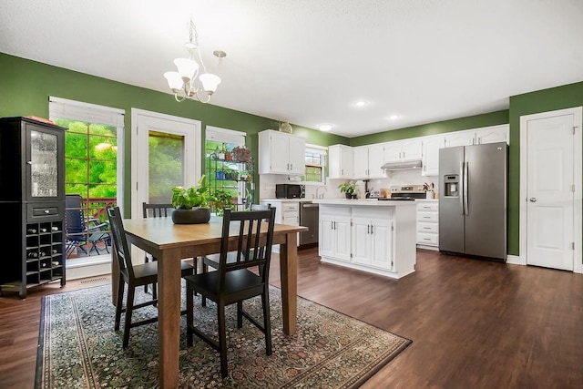 17525 W 111th Ct, Olathe, KS 66061 - dining area featuring dark wood finished floors, a chandelier, and recessed lighting