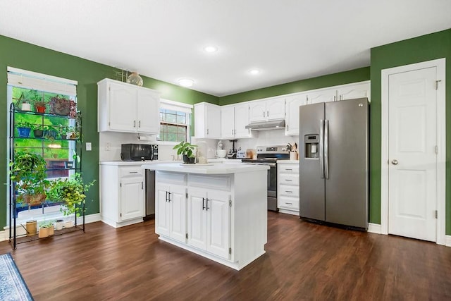 17525 W 111th Ct, Olathe, KS 66061 - kitchen featuring appliances with stainless steel finishes, under cabinet range hood, dark wood finished floors, light countertops, and recessed lighting
