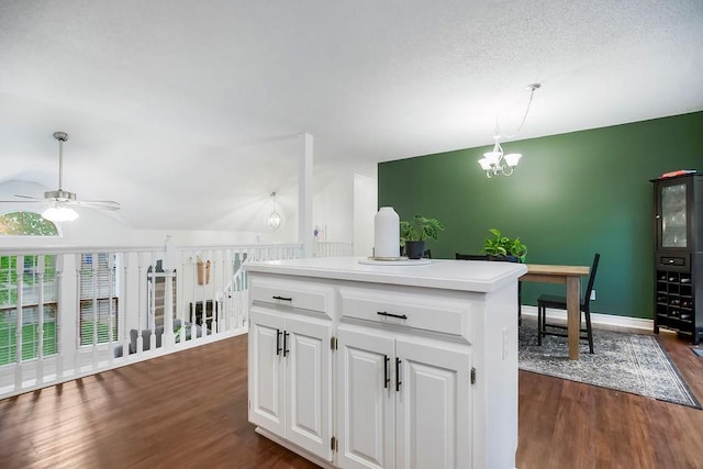 17525 W 111th Ct, Olathe, KS 66061 - kitchen with a ceiling fan, dark wood-style flooring, white cabinets, a chandelier, and decorative light fixtures