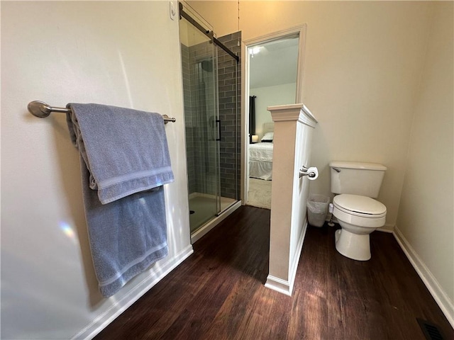 17525 W 111th Ct, Olathe, KS 66061 - ensuite bathroom featuring wood finished floors, a stall shower, baseboards, and toilet