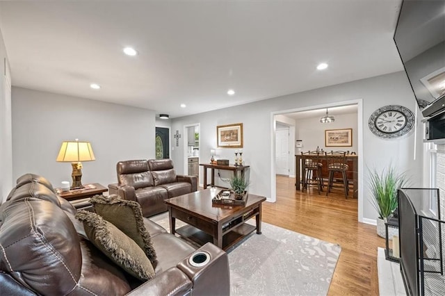 living area featuring recessed lighting and light wood-style floors