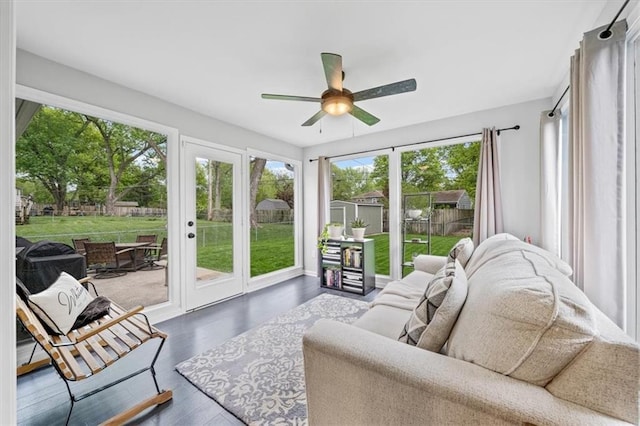sunroom with plenty of natural light, french doors, and wood finished floors