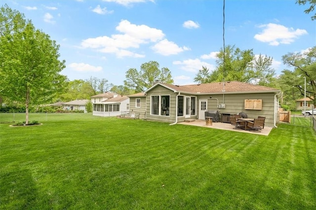 back of house with a patio area, fence, and a yard