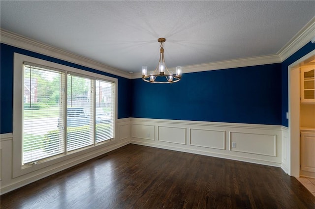 unfurnished room featuring a chandelier, a wainscoted wall, a textured ceiling, and dark wood-type flooring