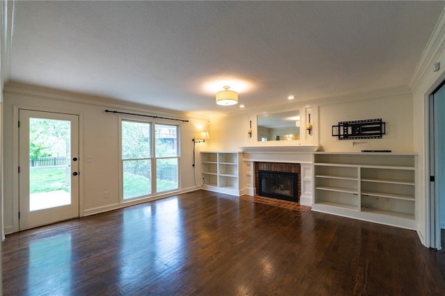 unfurnished living room with ornamental molding, a textured ceiling, and wood finished floors
