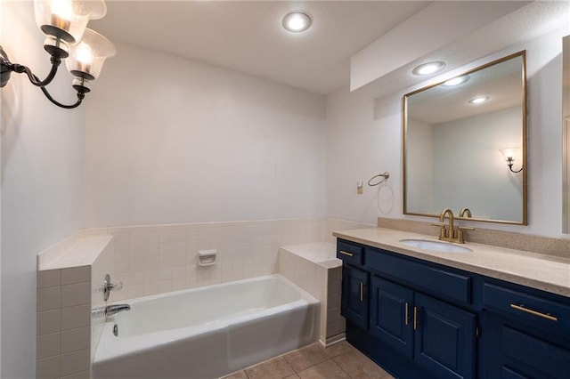 full bath featuring a garden tub, vanity, recessed lighting, and tile patterned flooring