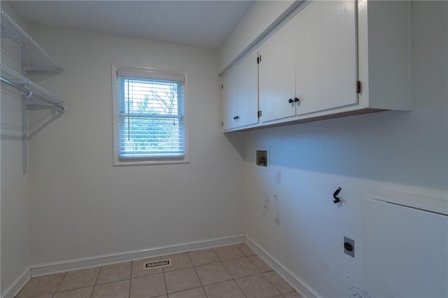 washroom featuring hookup for an electric dryer, washer hookup, visible vents, baseboards, and cabinet space