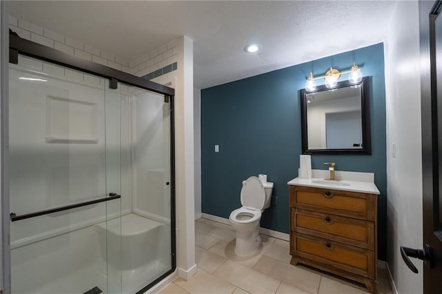 bathroom featuring recessed lighting, vanity, toilet, a stall shower, and tile patterned flooring