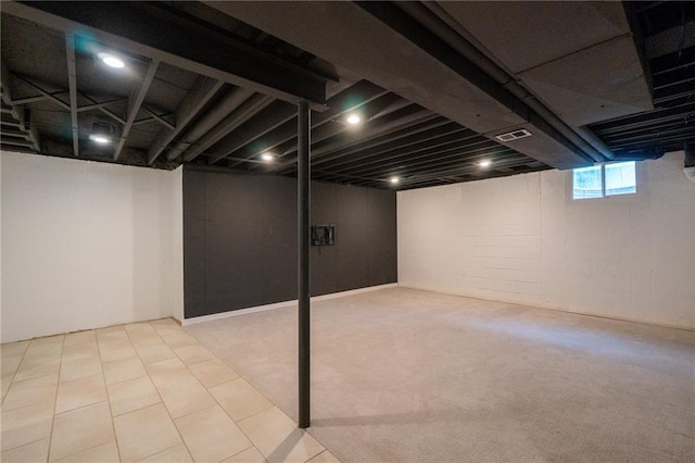 below grade area featuring visible vents and carpet floors