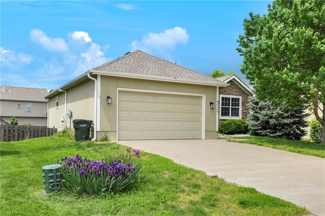 2136 Alder St, Leavenworth, KS 66048 - view of front of home featuring fence, a garage, stucco siding, a front yard, and driveway